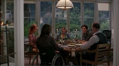 a group of people sitting around a dinner table