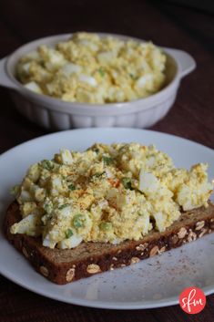 there is a piece of bread with eggs on it and another bowl of food in the background