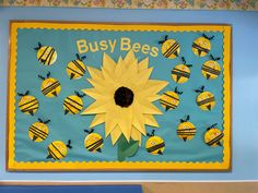 the bulletin board is decorated with bees and a sunflower on it's side