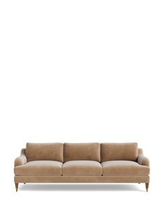 a beige couch sitting on top of a white floor