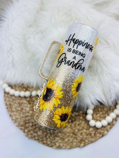 a cup with sunflowers painted on it and the words happiness is being grateful