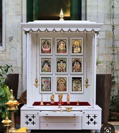 a shrine with pictures on the wall in front of it