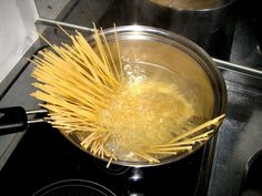 pasta being cooked in a pot on the stove