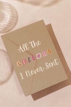 a card that says, all the letters i never sent are on top of a table