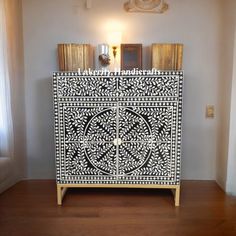 an ornate white and black cabinet in a room