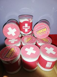 a pile of red and white cups sitting next to each other on top of a table