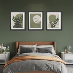 a bedroom with green walls and two pictures on the wall above the bed in front of the bed