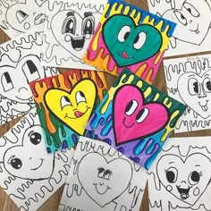 four different colored hearts with faces drawn on them, all in different colors and shapes