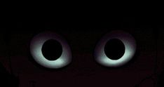 an evil looking face in the dark with two eyes and one eyeball on it's head