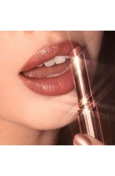 What it is: A sumptuous, star-lit glossy lipstick for kiss-worthy, wider-looking lips.What it does: This gloss delivers full, pillowy lips. It's formulated with polymers, which create an excellent soft, elegant, silk-feeling film to enhance wear, imparting a luscious, wet, shiny glossy finish. Brilliant emollient oil leaves lips with a heavy gloss, while magic diamond powder provides sparkling photoluminescence. Hyaluronic acid hydrates your lips.How to use: Swipe onto lips directly from the bul Charlotte Tilbury Superstar Lips, Glossy Lipstick, Peach Lipstick, Glossier Lipstick, Mascara Set, Sheer Lipstick, Kim K Style, Jessie James, Natural Lipstick