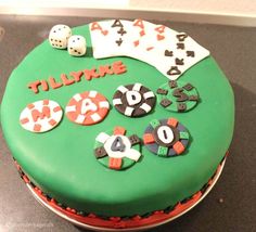 a green cake decorated with casino chips and dice