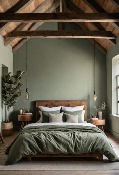 a bedroom with green walls and wooden beams