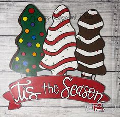 this is an image of a wooden sign with christmas trees and candy canes on it