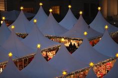 many tents are decorated with christmas lights and decorations