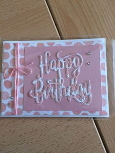 a pink and white birthday card with the words happy birthday written in frosting on it