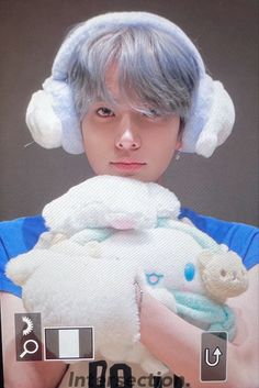 a person holding a stuffed animal in their hands