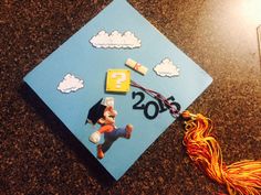 a graduation cap with the number twenty five on it and some decorations attached to it