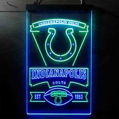 the indianapolis colts neon sign is lit up with blue and green lights, along with an american football logo