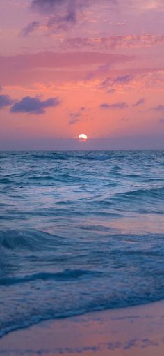 the sun is setting over the ocean with waves