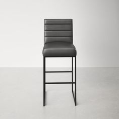 a gray leather chair sitting on top of a white floor