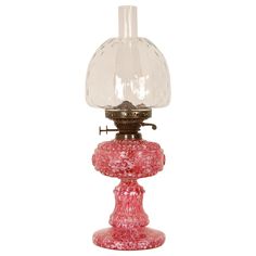 a pink glass table lamp on a white background