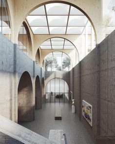 the inside of a building with arched ceilings and stone arches on either side of it