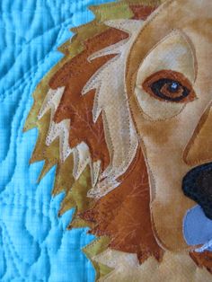 a close up of a dog's face on a quilt