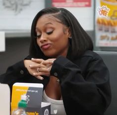 a woman sitting in front of a laptop computer