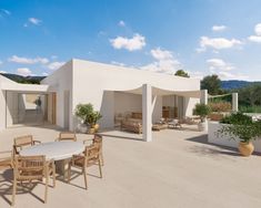 an outdoor dining area with tables and chairs on the patio, surrounded by greenery