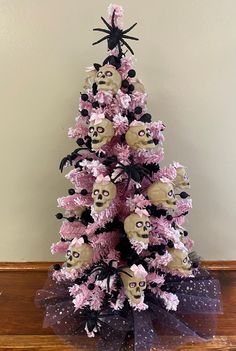 a pink and black christmas tree with skulls on it