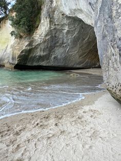 the beach is next to some large rocks