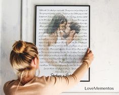 a woman is looking at a poster with the words love mementoos on it