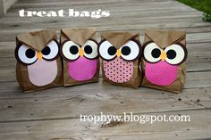 three bags with owls on them sitting on a wooden floor next to each other and the words treat bags written in large letters