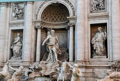 statues and fountains in front of a building