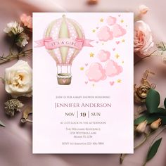 a pink and white baby shower party with hot air balloon on it's back