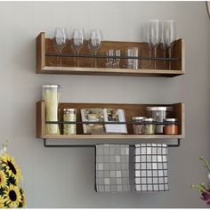 two wooden shelves filled with glasses and other items