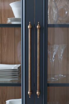 an image of a cabinet with glass doors and plates on the shelves in front of it