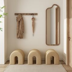 three stools in front of a mirror and coat rack