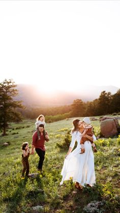 a group of people that are standing in the grass