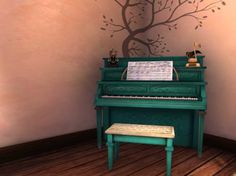 a green piano sitting in front of a wall with a tree painted on it's side