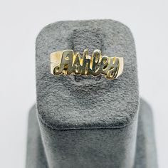 Introducing our sleek and stylish custom name ring, available in luxurious 10K or 14K solid gold. This bold piece makes a statement, featuring a high-polished, golden finish that gleams with sophistication. The nameplate is designed in a chic, cursive font, crafted to stand out while remaining timeless and classy. Whether it's your name, a loved one's, or any meaningful word, this ring transforms it into a wearable work of art. The perfect blend of urban flair and elegance, this piece is crafted Picture Pendant, Initial Earrings, Name Ring, Cursive Font, Name Rings, Initial Ring, Name Jewelry, Finger Rings, Meaningful Words