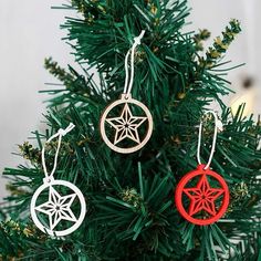 three wooden ornaments hanging from a christmas tree