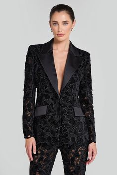 Valia Black Blazer Women's Clothing > Blazer. DESCRIPTION &  FEATURES  Discover a modern twist on classic tailoring with our VALIA blazer, crafted from sheer black velvet embroidered lace, revealing just a hint of skin. This blazer features a contrast satin lapel, internal shoulder pads, and elegant scallop detailing to the hem and sleeves. Finished with satin buttons to the sleeve cuff and non-functional pockets to the front. Fully lined for a smooth fit.    Pair with our VALIA Black Pants to complete the look.     - Signature structured blazer shape        - Sheer black velvet embroidered lace    - Internal shoulder pads    - Structured    - Single breasted    - Satin contrast lapel and functional button to the front      - Full-length sleeves lined in sheer black mesh    - Scallop detai Nadine Merabi, Structured Blazer, Classic Tailoring, Pajama Suit, Black Trousers, Sleeve Cuff, Black Blazer, Embroidered Lace, Black Mesh