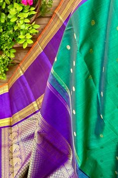 This stunning emerald green Kanjivaram silk saree is a handwoven masterpiece. The intricate gold zari buttas on the body add a touch of elegance, while the purple borders and grand pallu make for a striking contrast. Elevate your traditional wardrobe with this regal piece. Approximate Length 6.5 mtrs (inclusive of blouse length) Approximate Height - 48 - 52" Approximate weight - 1.6 lbs Saree comes with fall, picot and tassels done when applicable. Blouse piece is cut. Kindly Note : The colors you see on your device may vary due to the color reproduction, brightness and resolution of individual devices. If you'd like more clarity before your purchase, please contact our support team. Green Wedding Saree With Tilla Work, Green Wedding Saree With Tilla Details, Festival Tilla Dupatta, Multicolor Paithani Silk Saree With Tilla, Multicolor Paithani Silk Saree With Tilla Details, Green Anarkali Dupatta With Tilla, Green Tilla Dupatta For Anarkali, Anarkali Green Dupatta With Tilla Detailing, Anarkali Style Green Dupatta With Tilla