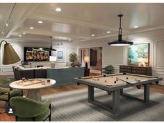 a living room filled with furniture and a pool table in front of a flat screen tv