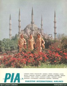 two women in hijab standing next to flowers and a building with minas on it