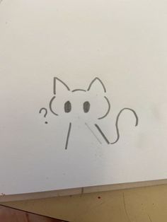 a drawing of a cat with a question mark in it's mouth on a piece of paper