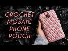 a hand holding up a pink cell phone case with the text crochet mosaic phone pouch