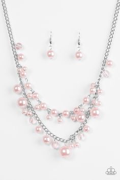 a necklace and earring set with pink pearls on a silver chain hanging from the neck