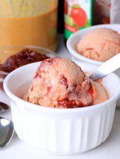 two bowls filled with ice cream next to spoons